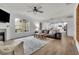 Bright living room featuring a fireplace, large windows, hardwood floors, and a comfortable seating arrangement at 4040 Grandview Manor Dr, Cumming, GA 30028
