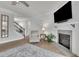 Comfortable living room showcasing a fireplace, hardwood floors, and a staircase leading to the upper level at 4040 Grandview Manor Dr, Cumming, GA 30028