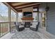 Screened porch boasts a brick fireplace, TV, comfortable seating, and seamless indoor-outdoor living at 4040 Grandview Manor Dr, Cumming, GA 30028