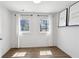 A bright bedroom with wood floors, two windows, and modern decor at 2036 Bixby Byway Se Dr, Atlanta, GA 30317