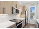 Bright kitchen showcases stainless steel appliances, modern backsplash, and sleek countertops at 2036 Bixby Byway Se Dr, Atlanta, GA 30317