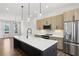 Spacious kitchen includes island, stainless appliances, light cabinets and modern pendant lighting at 2036 Bixby Byway Se Dr, Atlanta, GA 30317