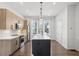 Contemporary kitchen with island, stainless appliances, light cabinets and modern pendant lighting at 2036 Bixby Byway Se Dr, Atlanta, GA 30317