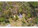 Bird's-eye view of a property with mature trees and multiple structures on the grounds at 3960 Mason Creek Rd, Winston, GA 30187