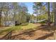 Sprawling backyard with mature trees and several outbuildings, offering ample storage and potential at 3960 Mason Creek Rd, Winston, GA 30187