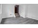 Unfinished basement with gray plank flooring and stairs to the main level, offering renovation potential at 3960 Mason Creek Rd, Winston, GA 30187