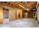Unfinished basement featuring wood paneling and exposed ceiling beams, providing rustic charm and potential at 3960 Mason Creek Rd, Winston, GA 30187