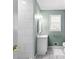 Fresh bathroom showcasing white tiles, a modern vanity, and a well-lit mirror, offering a serene space at 3960 Mason Creek Rd, Winston, GA 30187