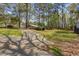 Long driveway leading to various outbuildings and a residence, surrounded by trees and lawn at 3960 Mason Creek Rd, Winston, GA 30187