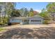 Charming single-story home with light blue siding, and a driveway, set among mature trees at 3960 Mason Creek Rd, Winston, GA 30187