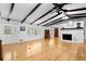 Spacious living room with hardwood floors, fireplace, and beamed ceiling at 3960 Mason Creek Rd, Winston, GA 30187