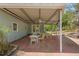 Inviting covered patio with brick flooring, perfect for outdoor dining and relaxation, featuring ceiling fans and ample space at 3960 Mason Creek Rd, Winston, GA 30187