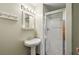 Cozy bathroom featuring a pedestal sink, frameless glass shower, and neutral color palette at 5200 Peachtree Rd # 3324, Chamblee, GA 30341