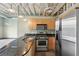 Well-equipped kitchen with stainless steel appliances, black countertops, and stylish lighting at 5200 Peachtree Rd # 3324, Chamblee, GA 30341