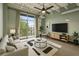Bright, modern living room featuring floor to ceiling windows, sleek furniture, and stylish decor at 5200 Peachtree Rd # 3324, Chamblee, GA 30341