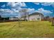Large backyard featuring lush green space and privacy fence, perfect for outdoor activities at 605 Oak Terrace Drive, Covington, GA 30016