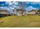 Expansive backyard with mature tree offers shade and a serene outdoor setting at 605 Oak Terrace Drive, Covington, GA 30016