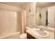 A modest bathroom, featuring a tub, toilet, mirror, single vanity sink, and essential amenities for daily use at 605 Oak Terrace Drive, Covington, GA 30016