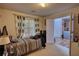 A cozy bedroom featuring carpet, window with curtains, and a doorway leading into the adjacent room at 605 Oak Terrace Drive, Covington, GA 30016