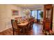 A spacious dining room is highlighted by an elegant chandelier, wainscoting, and hardwood floors at 605 Oak Terrace Drive, Covington, GA 30016
