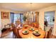 Elegant dining room with hardwood floors, a large table set for eight, and decorative chandelier and built-in hutch at 605 Oak Terrace Drive, Covington, GA 30016