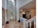 A well lit foyer with a two story ceiling, hard wood floors, and a white front door at 605 Oak Terrace Drive, Covington, GA 30016