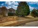 Landscaped front yard featuring mature trees and well-maintained lawn leading to home at 605 Oak Terrace Drive, Covington, GA 30016