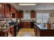 This eat-in kitchen features tile flooring, cabinetry, a dual basin sink, and an island with granite countertops at 605 Oak Terrace Drive, Covington, GA 30016