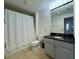 Clean bathroom with shower-tub combo, toilet, granite vanity and tiled floors at 195 14Th St # 1005, Atlanta, GA 30309
