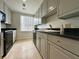 Well lit Kitchen with stainless steel appliances, granite countertop, and tiled flooring at 195 14Th St # 1005, Atlanta, GA 30309