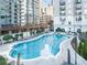 Beautiful outdoor pool with lounge chairs surrounded by lush landscaping and luxury apartments at 195 14Th St # 1005, Atlanta, GA 30309