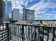 A stunning view from the balcony showcasing the city skyline and lush green trees at 195 14Th St # 1005, Atlanta, GA 30309