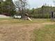Expansive backyard features ample green space, a playground, and a charming shed at 2814 Michelle Lee Dr, Dacula, GA 30019