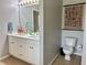 Bathroom featuring dual sink vanity with gold hardware and adjacent toilet area at 2814 Michelle Lee Dr, Dacula, GA 30019
