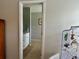 Bathroom entrance showcasing tiled flooring and a vanity with white cabinets and gold hardware at 2814 Michelle Lee Dr, Dacula, GA 30019