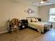 Bedroom with hardwood floors, art pieces, a desk, chair and a window at 2814 Michelle Lee Dr, Dacula, GA 30019