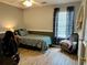 Bedroom featuring wood-look floors, two-tone walls, and a bright window with blackout curtains at 2814 Michelle Lee Dr, Dacula, GA 30019