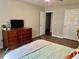 This bedroom features a dresser, wood-look flooring, and a ceiling fan for comfort and style at 2814 Michelle Lee Dr, Dacula, GA 30019