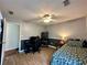 Bedroom with wood-look flooring, neutral paint, gaming setup, and a comfortable bed at 2814 Michelle Lee Dr, Dacula, GA 30019
