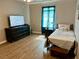 Bedroom with hardwood floors, a ceiling fan, a window and a TV set at 2814 Michelle Lee Dr, Dacula, GA 30019