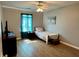 Bedroom with hardwood floors, a ceiling fan, window and curtains at 2814 Michelle Lee Dr, Dacula, GA 30019
