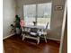 Charming breakfast nook with a wood-top table, bench, and chairs, situated by a window with plants at 2814 Michelle Lee Dr, Dacula, GA 30019