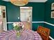 Bright dining room with decorative wallpaper, a round table, and a view to a hallway with skylight for a light-filled space at 2814 Michelle Lee Dr, Dacula, GA 30019