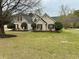 Charming home featuring a brick facade, dormer windows and manicured landscaping at 2814 Michelle Lee Dr, Dacula, GA 30019
