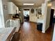 Open-concept kitchen featuring white cabinets, stainless steel appliances, and hardwood floors extending to a dining area at 2814 Michelle Lee Dr, Dacula, GA 30019