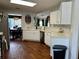 Bright, airy kitchen with white cabinets, stainless steel appliances, and hardwood floors that opens to the dining area at 2814 Michelle Lee Dr, Dacula, GA 30019