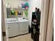 Laundry room featuring modern washer and dryer units with storage shelving at 2814 Michelle Lee Dr, Dacula, GA 30019