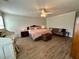 Bright bedroom featuring a large bed, hardwood floors, and a comfortable seating area, creating a relaxing and inviting atmosphere at 2814 Michelle Lee Dr, Dacula, GA 30019