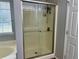 Bathroom featuring an enclosed shower with a glass door, and a window at 2814 Michelle Lee Dr, Dacula, GA 30019