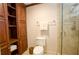 Bathroom with tiled shower, a cabinet for storage, and a commode with a towel rack above it at 4495 Glengary Ne Dr, Atlanta, GA 30342